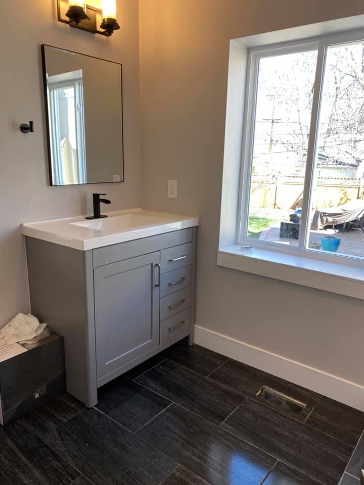 Modern construction bathroom vanity with dark fixtures after post-build clean