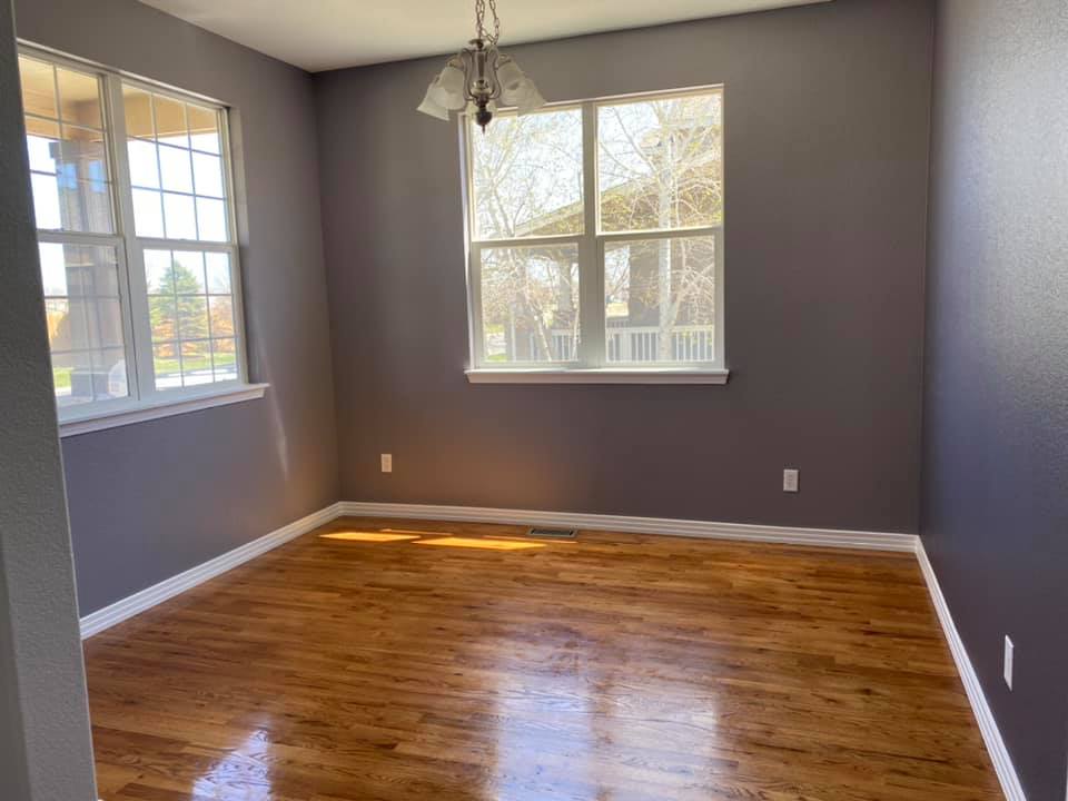 Open dining room with gleaming hardwood floors after deep clean