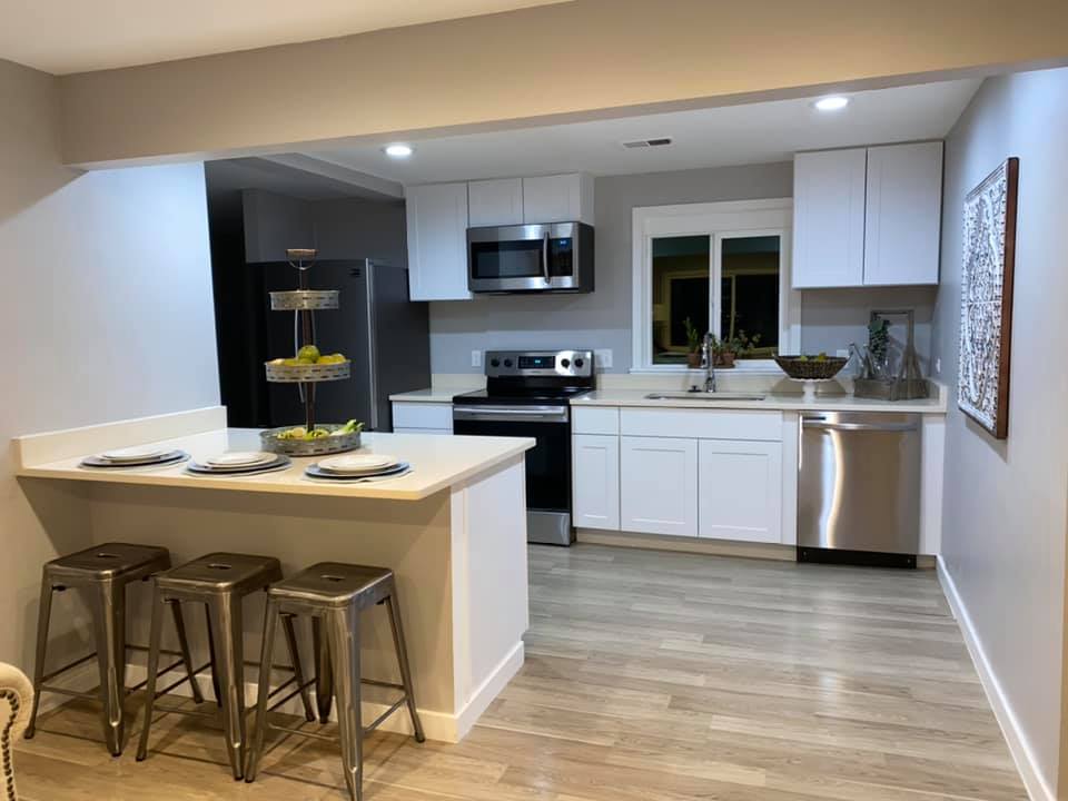 White shaker kitchen with stainless appliances after professional clean