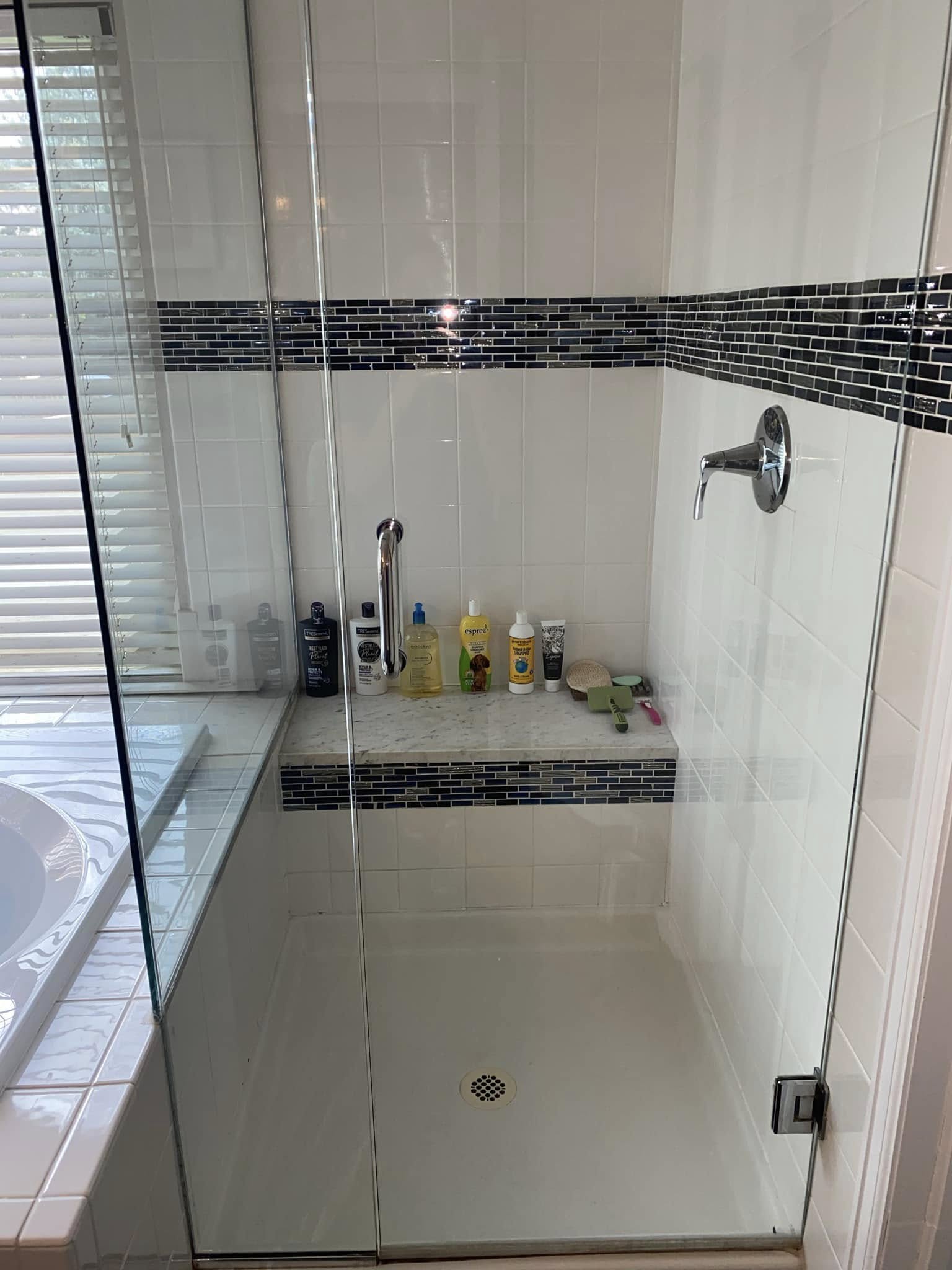 Walk-in shower with frameless glass after thorough deep clean